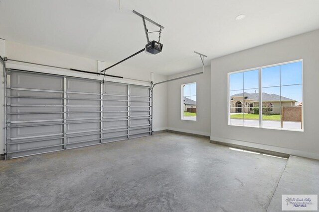 25219 Chelsea Ln, Harlingen, TX 78552 - garage featuring a garage door opener and baseboards