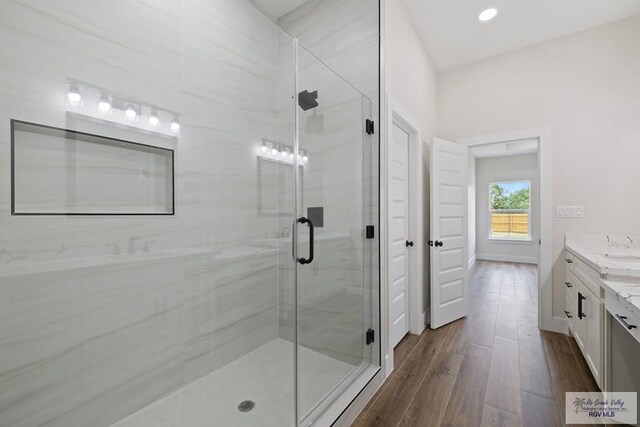 25219 Chelsea Ln, Harlingen, TX 78552 - bathroom with vanity, wood finished floors, a stall shower, and recessed lighting
