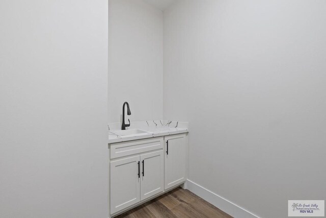 25219 Chelsea Ln, Harlingen, TX 78552 - detailed view of a sink, wood finished floors, and baseboards