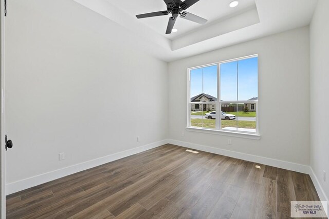 25219 Chelsea Ln, Harlingen, TX 78552 - spare room featuring a tray ceiling, baseboards, wood finished floors, ceiling fan, and recessed lighting