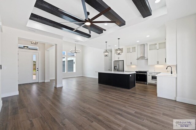 25219 Chelsea Ln, Harlingen, TX 78552 - kitchen featuring appliances with stainless steel finishes, wall chimney range hood, open floor plan, a kitchen island, and a chandelier
