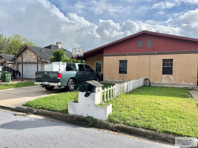 view of side of property with a lawn