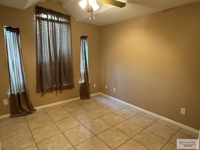 tiled spare room with ceiling fan