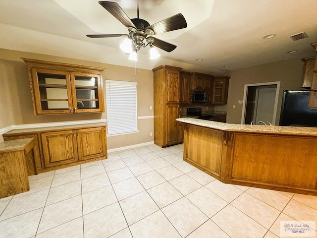 kitchen with light tile patterned flooring, kitchen peninsula, ceiling fan, and appliances with stainless steel finishes