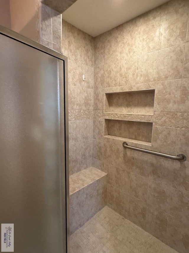 bathroom featuring a tile shower