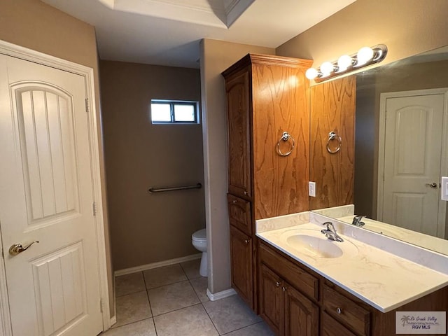 bathroom featuring vanity, toilet, and tile patterned flooring