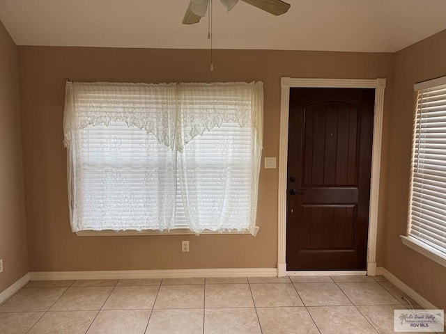 entryway with ceiling fan and light tile patterned flooring