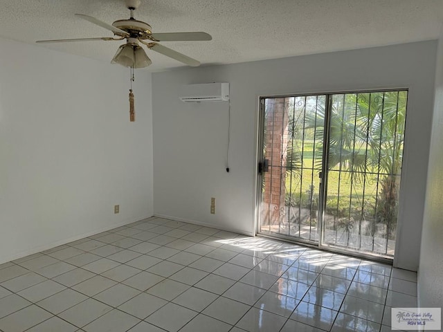 tiled spare room with a textured ceiling, an AC wall unit, and ceiling fan