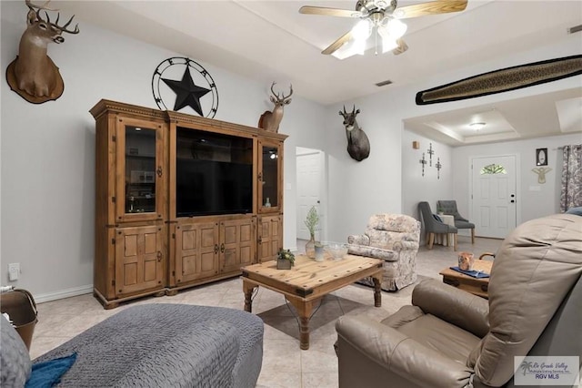 tiled living room with ceiling fan