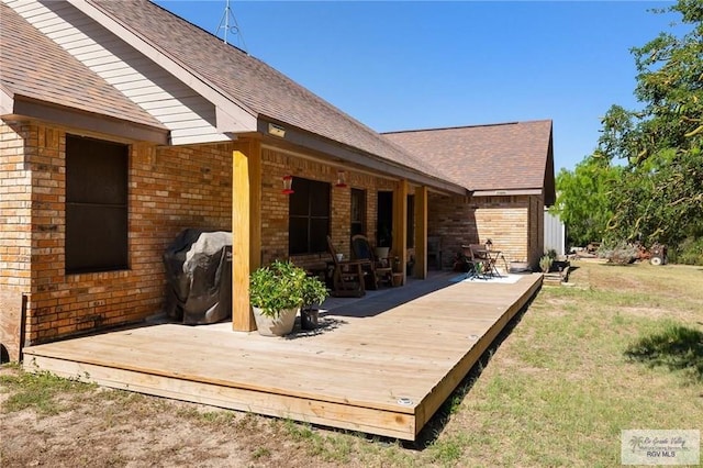 rear view of property featuring a deck