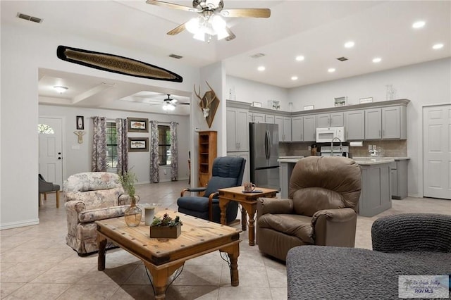 living room with ceiling fan, sink, and light tile patterned floors