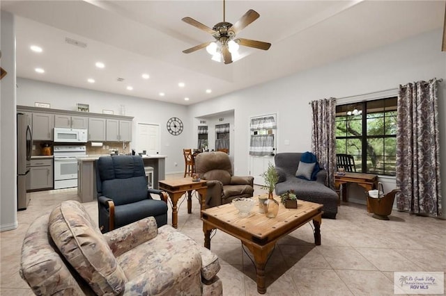 living room with ceiling fan and light tile patterned flooring