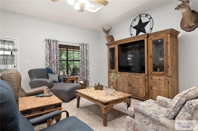 living room with ceiling fan and light tile patterned floors