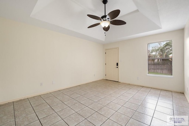 5 Mantua St, Brownsville, TX 78526 - empty room featuring a raised ceiling, a ceiling fan, and light tile patterned flooring