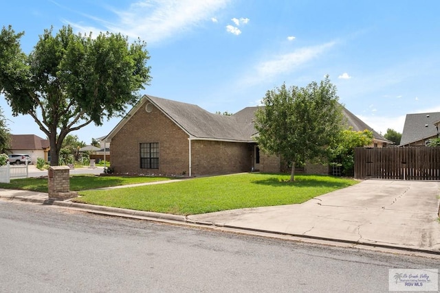 5 Mantua St, Brownsville, TX 78526 - view of front facade with brick siding and concrete driveway