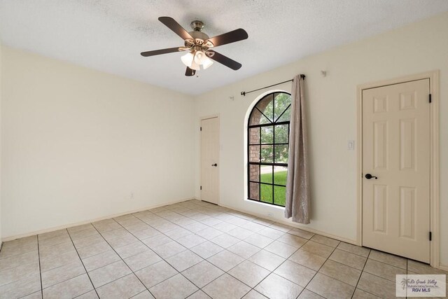 5 Mantua St, Brownsville, TX 78526 - empty room featuring a ceiling fan, light tile patterned floors, and a textured ceiling