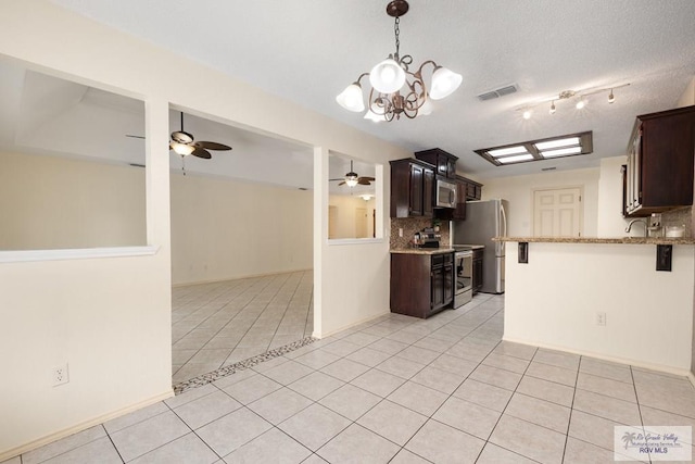 5 Mantua St, Brownsville, TX 78526 - kitchen with decorative backsplash, ceiling fan, light tile patterned floors, appliances with stainless steel finishes, and dark brown cabinets