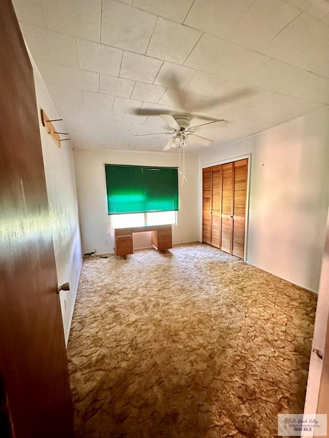 697 W White Ave, Raymondville, TX 78580 - unfurnished bedroom featuring a closet, carpet flooring, and ceiling fan