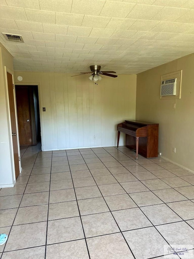 697 W White Ave, Raymondville, TX 78580 - unfurnished room featuring visible vents, a ceiling fan, a wall mounted AC, and light tile patterned flooring