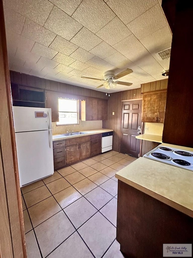 697 W White Ave, Raymondville, TX 78580 - kitchen with white appliances, light tile patterned floors, light countertops, ceiling fan, and a sink