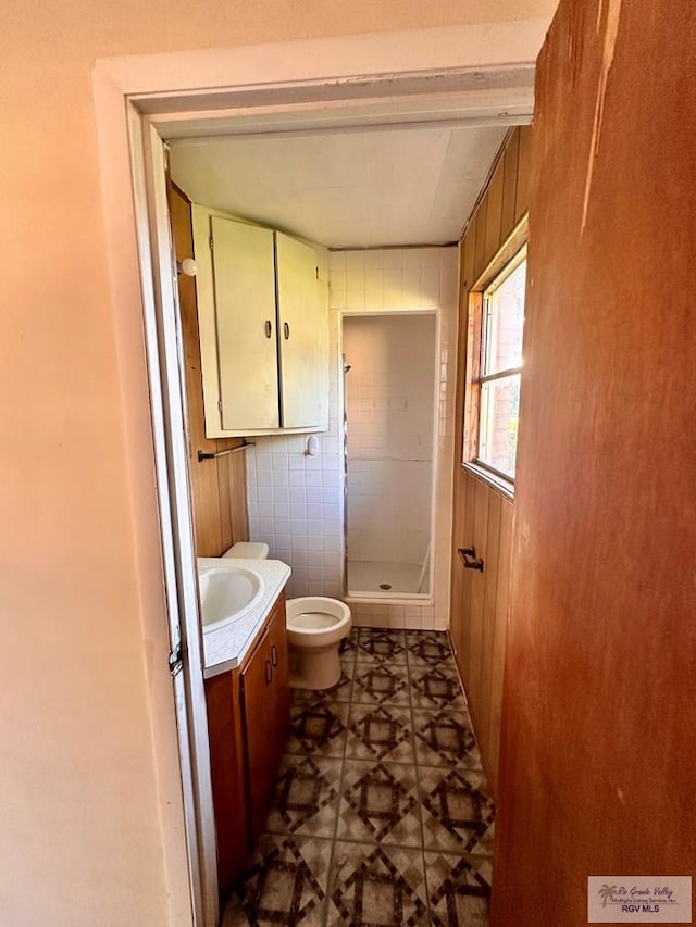 697 W White Ave, Raymondville, TX 78580 - full bath with toilet, a stall shower, vanity, and wooden walls