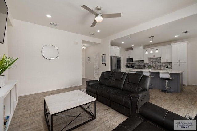 3214 W Hapner St, Harlingen, TX 78550 - living area with a ceiling fan, light wood-style floors, and recessed lighting