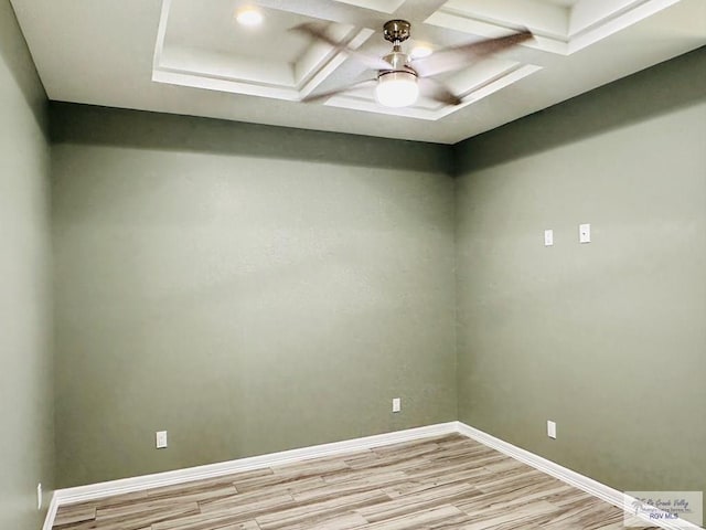 empty room with light hardwood / wood-style floors, beam ceiling, and coffered ceiling