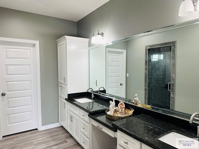 bathroom with vanity, an enclosed shower, and hardwood / wood-style flooring