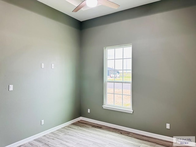 empty room with ceiling fan and light hardwood / wood-style floors