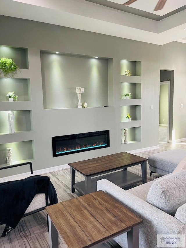 living room with wood-type flooring and built in features