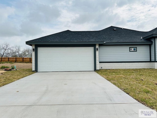 view of side of property featuring a garage and a yard