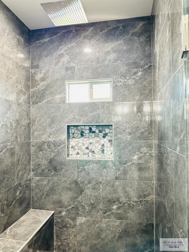 bathroom featuring a tile shower