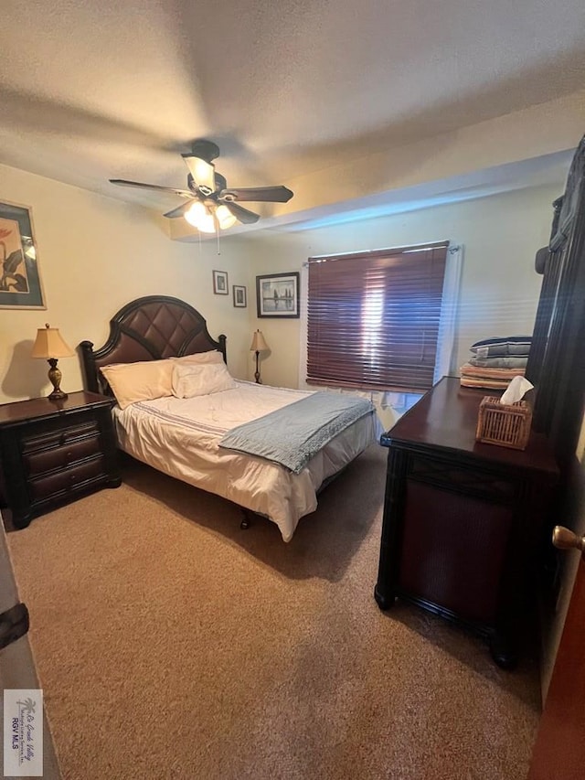 carpeted bedroom with a textured ceiling and ceiling fan