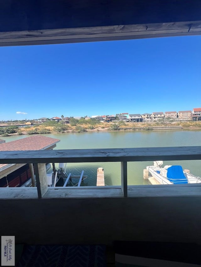 balcony featuring a dock and a water view