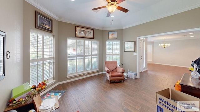 sitting room with hardwood / wood-style floors, ceiling fan with notable chandelier, and ornamental molding