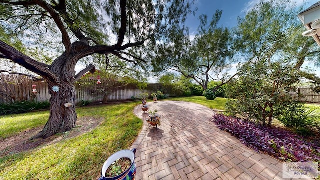 surrounding community with a patio area and a lawn