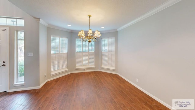 unfurnished dining area featuring hardwood / wood-style flooring, an inviting chandelier, a healthy amount of sunlight, and crown molding