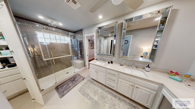 bathroom with vanity, tile patterned floors, a shower with door, and ceiling fan