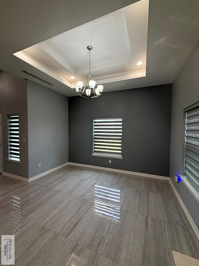 3585 Westcreek Dr, Brownsville, TX 78526 - unfurnished room featuring a tray ceiling and a chandelier