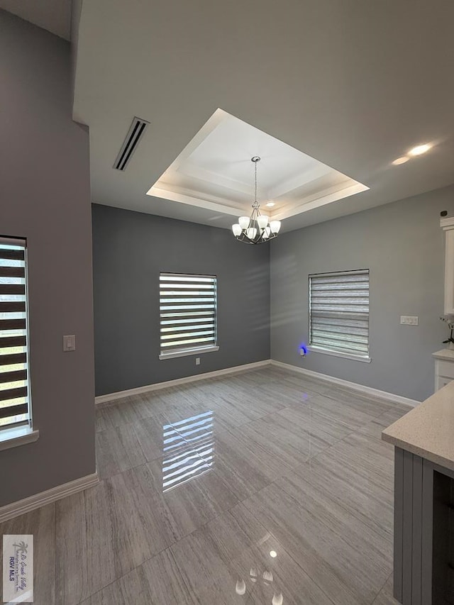 3585 Westcreek Dr, Brownsville, TX 78526 - unfurnished dining area featuring a raised ceiling and a chandelier