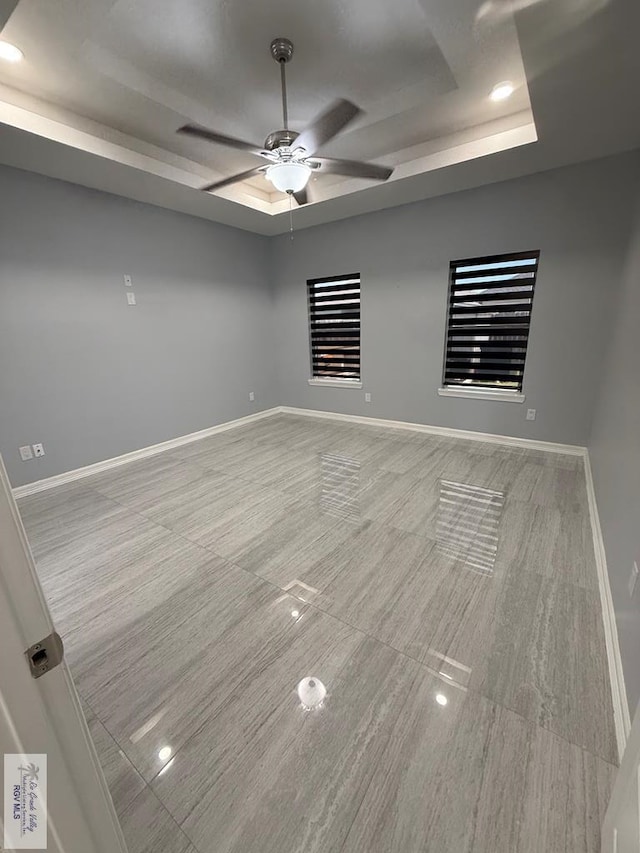 3585 Westcreek Dr, Brownsville, TX 78526 - empty room featuring a tray ceiling, ceiling fan, and recessed lighting