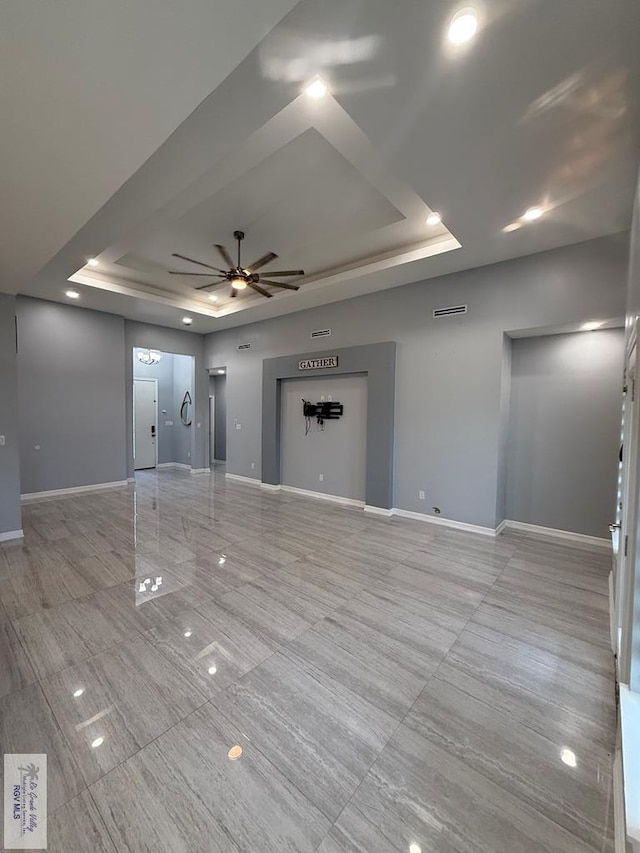 3585 Westcreek Dr, Brownsville, TX 78526 - unfurnished living room with a raised ceiling, a ceiling fan, and light tile patterned floors