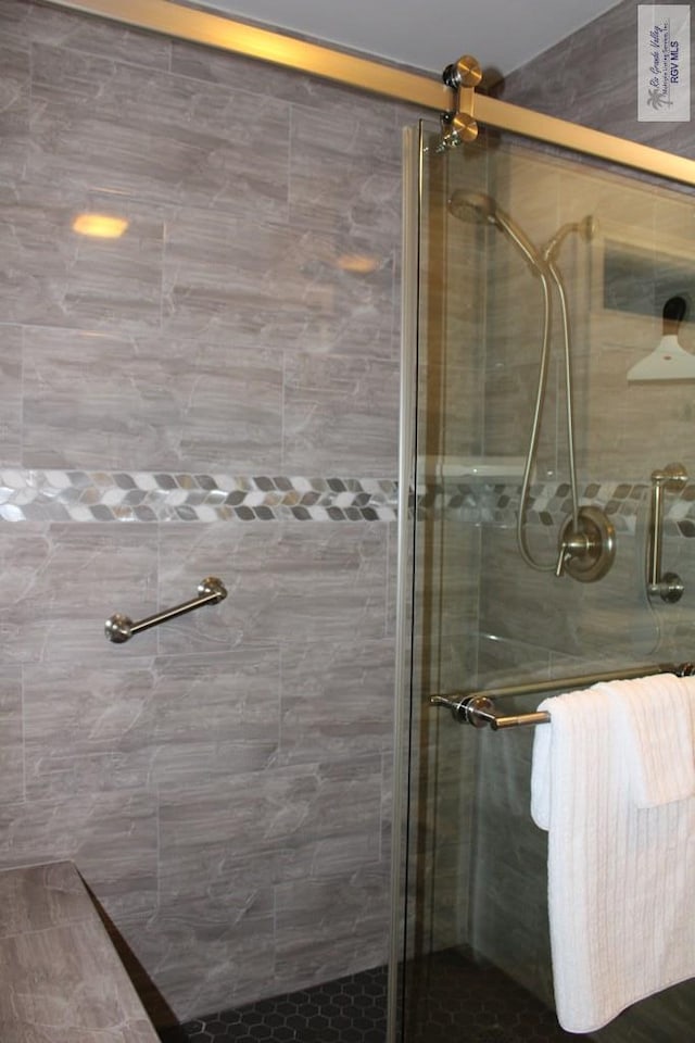 bathroom featuring a shower with door