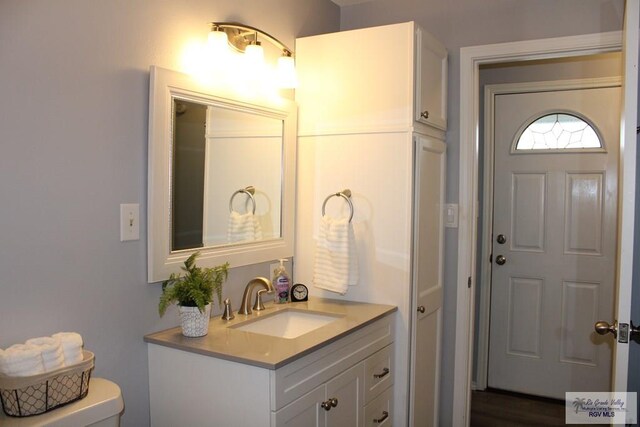 bathroom with toilet and vanity