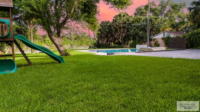 yard at dusk with a playground