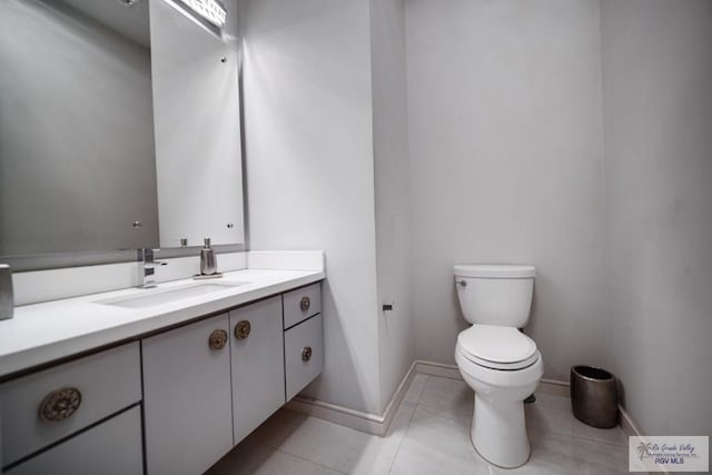 bathroom with tile patterned floors, vanity, and toilet