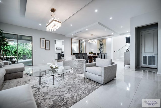 tiled living room featuring an inviting chandelier