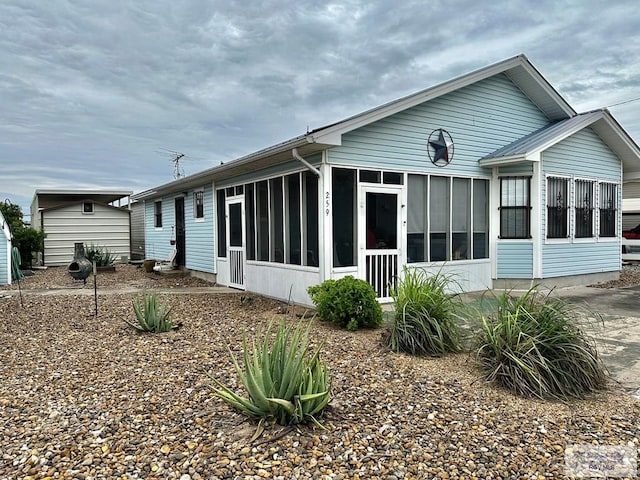 back of house featuring a sunroom