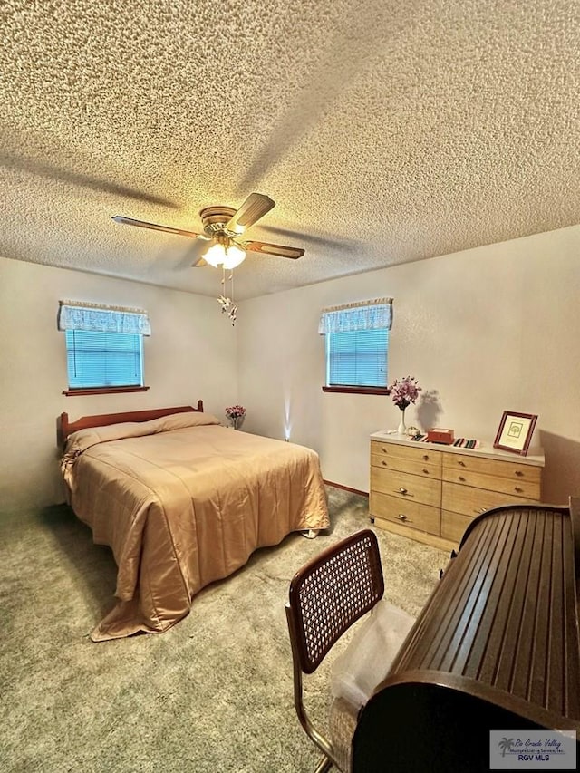 bedroom with carpet, a textured ceiling, and ceiling fan