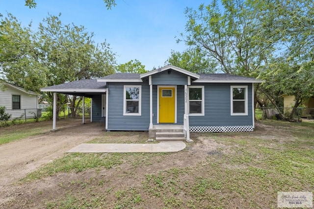 1522 Ball St, Harlingen, TX 78550 - view of front of property with a carport, dirt driveway, and entry steps